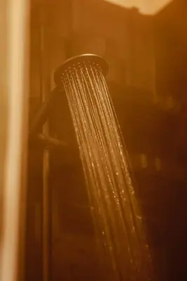 a shower head with droplets of water on it at Homnest - Infusion Provençale - Lisière & Ocres in Viens