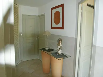 a hallway with a table with a lamp on it at Villa in Reillanne with Private Pool in Reillanne