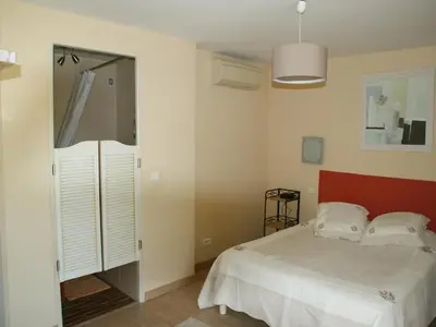 a bedroom with a bed and a sliding glass door at Villa in Reillanne with Private Pool in Reillanne
