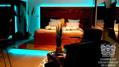 a bedroom with a bed with a blue light at Cocon D'amour En Luberon - Chambre Spa a proximite de l'Isle sur la Sorgue in LʼIsle-sur-la-Sorgue