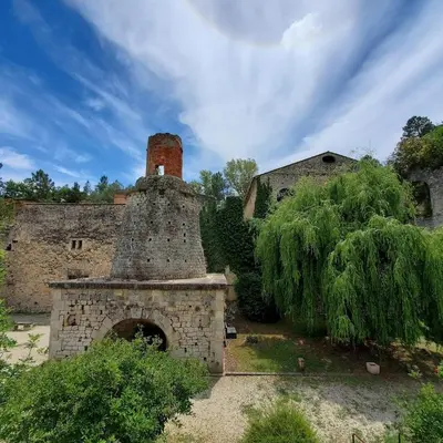 an old building with a brick oven with a tower at Au pied du Colorado Provencal in Rustrel