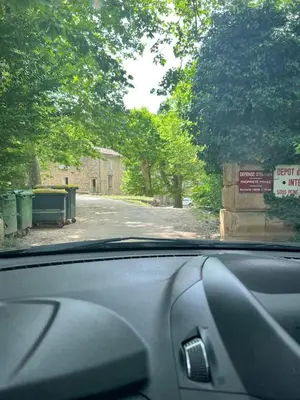 a view from a car windshield of a road with trees at Au pied du Colorado Provencal in Rustrel
