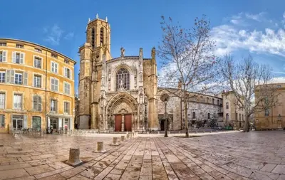 an old building with a tower and a church at Evasion Aixoise logement T2 au Centre historique in Aix-en-Provence