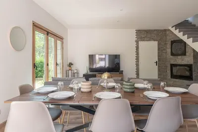 a dining room with a table and chairs at Villa le Trèfle with pool in Velaux