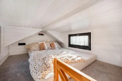 a bedroom with a bed and a window in a attic at Domaine Paradis in Reillanne