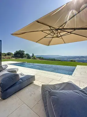 a patio with a swimming pool next to a house at Villa With Panoramic Views And Pool In Gordes in Gordes