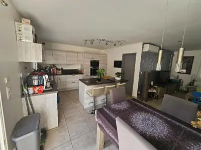 a large kitchen with a table in a room at Villa Eguilles, ensoleillée, piscine à 10 mn d' Aix en Provence in Éguilles