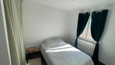 a small bedroom with a bed and a window at Maison climatisée avec jardin in Caumont-sur-Durance