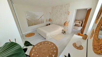 a small bedroom with a bed and a mirror at Cosy & Cocooning in Le Thor