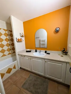 a bathroom with a sink and a mirror at Golf apartment in Saumane-de-Vaucluse