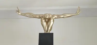 a bronze statue of a woman with her arms in the air at Appartement avec extérieur in LʼIsle-sur-la-Sorgue