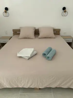 a bed with two towels and two pillows on it at Suite jacuzzi in Aix-en-Provence