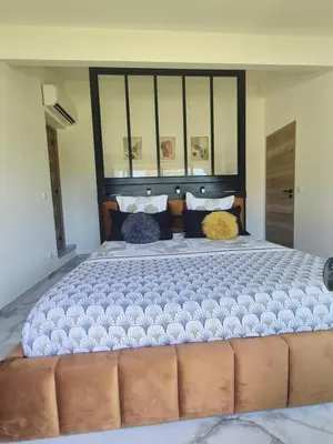 a large bed with two pillows on top of it at Ô nuits de saint cannat in Saint-Cannat