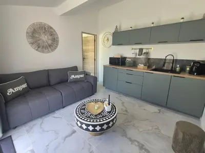 a living room with a couch and a table at Ô nuits de saint cannat in Saint-Cannat