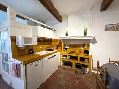 a small kitchen with white cabinets and a microwave at Le Manuel - Appart T2 cosy Centre ville historique - Place des Prêcheurs Palais de justice in Aix-en-Provence