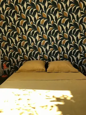 a bedroom with a black and white patterned wall at Maison entière avec jardin à 5 mn centre ville Aix en Provence in Aix-en-Provence