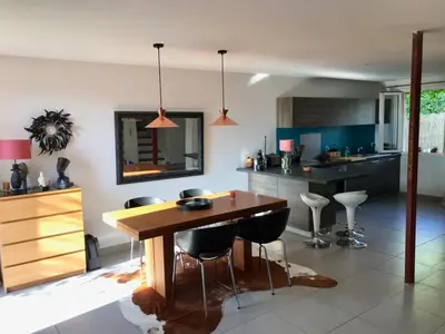a kitchen with a wooden table and some chairs at Maison entière avec jardin à 5 mn centre ville Aix en Provence in Aix-en-Provence