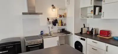 a small kitchen with a sink and a dishwasher at Le Triton, new appartments near city center , parking , lift in Aix-en-Provence