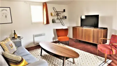 a living room with a couch and a tv at La Cachette centre historique village in Roussillon