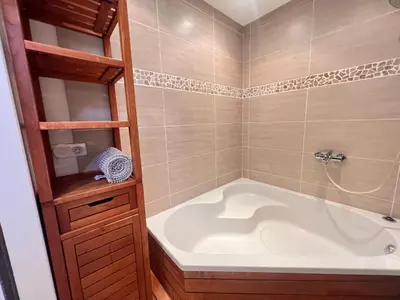 a bathroom with a white tub and a shower at La casa du Roy René in Aix-en-Provence
