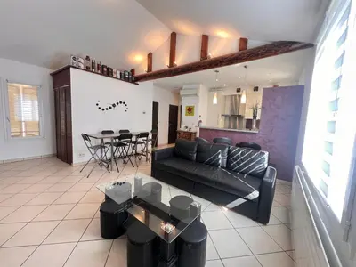 a living room with a couch and a table at La casa du Roy René in Aix-en-Provence