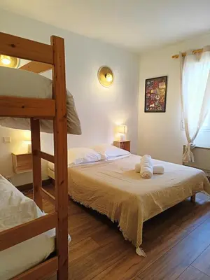 a bedroom with two bunk beds and a ladder at Au coeur des ocres in Roussillon