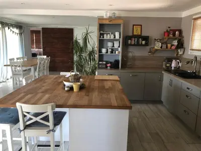 a kitchen with a wooden counter top in a room at Maison Luberon piscine in Viens