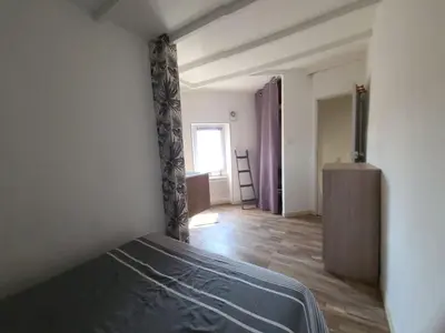 a bedroom with a bed and a wooden floor at Village House in Pélissanne near Luberon in Pélissanne