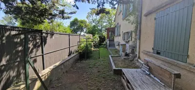 an air conditioner sitting in the grass next to a house at Family house in town centre 8 guest AC FreeParking in Aix-en-Provence
