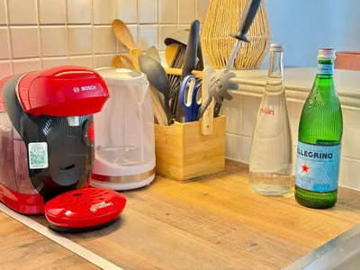 a kitchen counter with a red blender and a bottle at Refuge reposant - Centre ville - Espace Bureau in Aix-en-Provence