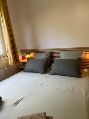 a bed with two pillows on it in a room at T2 Aurélia in Aix-en-Provence