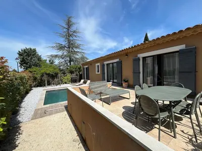 a patio with a table and chairs and a pool at House with a view of Luberon and a pool in Maubec