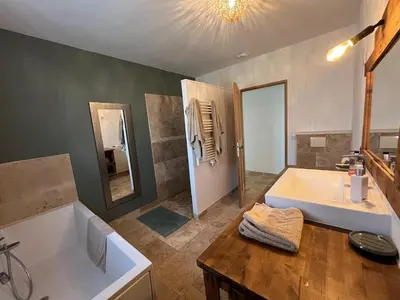 a large bathroom with a tub and a sink at House with a view of Luberon and a pool in Maubec