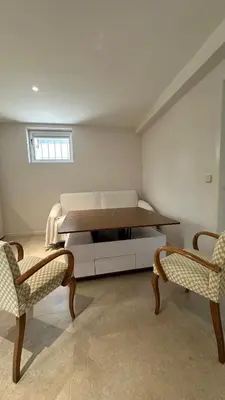 a room with a bed and two chairs and a table at Appartment 5 min walking from city center in Aix-en-Provence