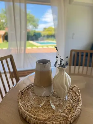 a table with a vase and two glasses on a table at Le Quatre Relax in Aix-en-Provence