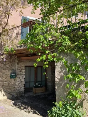 a stone building with a window and a tree at Il était une fois à Lagnes in Lagnes