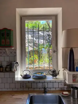 a kitchen with a sink and a window at Il était une fois à Lagnes in Lagnes