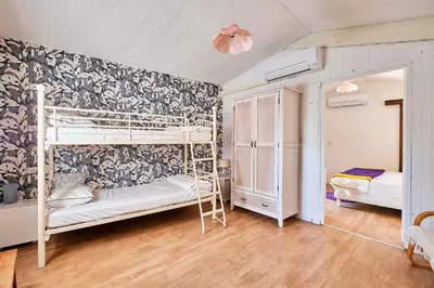 a bedroom with two bunk beds and a wall at Le Fort de Bramafan in Caumont-sur-Durance