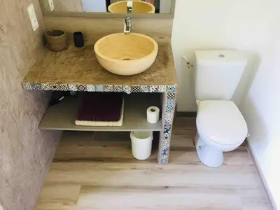 a bathroom with a sink and a toilet at Gîte ,studio dans le village de lagnes in Lagnes