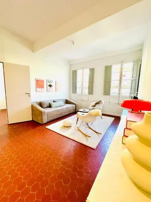 a living room with a couch and a table at Design and Provençal Elegance Suite in Aix in Aix-en-Provence
