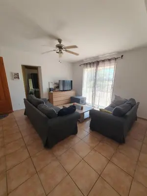 a living room with two couches and a tv at Évasion provençale in Saint-Cannat