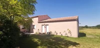 a small white house with a picnic table in a yard at Évasion provençale in Saint-Cannat