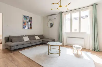 a living room with a couch and a table at Appartement confortable L'Éclat Doré in Pertuis