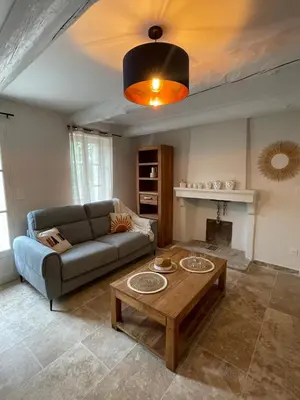 a living room with a couch and a coffee table at le mas au pied du Ventoux in Carpentras
