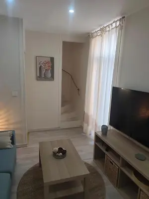 a living room with a large flat screen tv at Escapade dans le Luberon in Cavaillon
