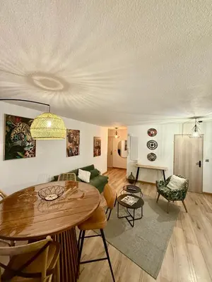 a living room with a table and a couch at Suite appartement in Châteaurenard