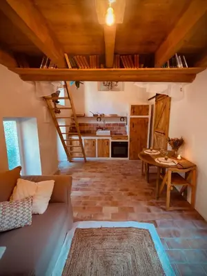 a living room with a couch and a table at Le mazet du cavalier in Puyvert