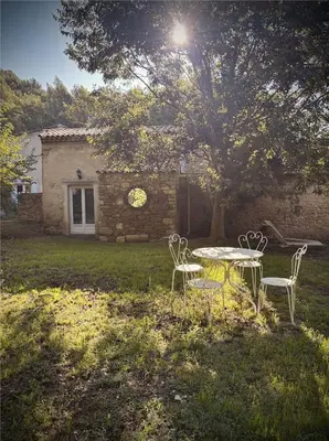 a table and chairs in front of a house at Le mazet du cavalier in Puyvert