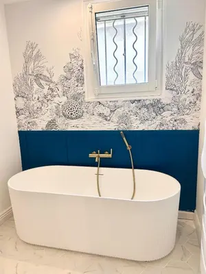 a bath tub in a bathroom with a blue wall at Villa de Seytres in Caumont-sur-Durance