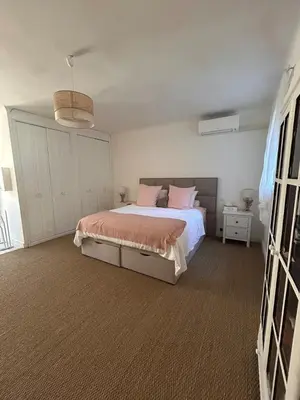 a bedroom with a bed with pink pillows at Villa de Seytres in Caumont-sur-Durance